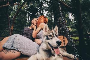 bellissimo coppia insieme con cane su un' swing foto
