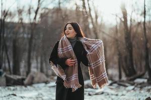 giovane bellissimo modello in posa nel inverno foresta. elegante moda ritratto foto