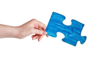 femmina mano con dipinto blu puzzle pezzo foto
