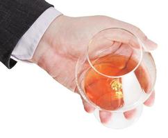sopra Visualizza di Cognac bicchiere nel uomo d'affari mano foto