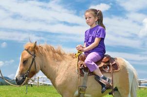 bambino cavalcata pony foto