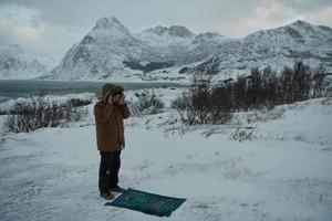 viaggiatore musulmano che prega in una fredda giornata invernale nevosa foto