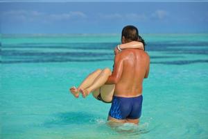 contento giovane coppia godendo estate su spiaggia foto