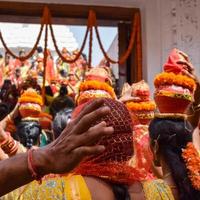 donne con kalash sulla testa durante il tempio di jagannath mangal kalash yatra, devoti indù indiani portano pentole di terracotta contenenti acqua sacra con una noce di cocco in cima foto