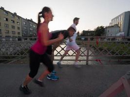 gruppo di giovani che fanno jogging attraverso il ponte foto