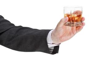 lato Visualizza di Whisky bicchiere nel uomo d'affari mano foto