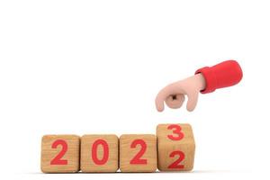 mano e cubi con 2022 - 23. rappresenta il nuovo anno 2023 foto