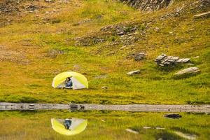 assonnato persona viso Guarda a partire dal tenda di lago foto