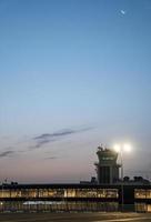 Visualizza di illuminato internazionale aeroporto con blu cielo nel sfondo a crepuscolo foto