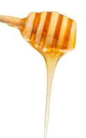 chiaro miele fluente giù a partire dal legna cucchiaio vicino su foto