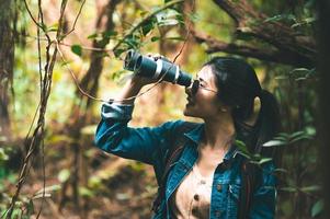 la donna sta birdwatching nella foresta