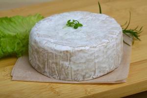 Camembert formaggio su di legno tavola e di legno sfondo foto