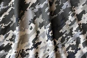 tessuto con struttura di ucraino militare pixeled camuffare. stoffa con Camo modello nel grigio, Marrone e verde pixel forme. ufficiale uniforme di ucraino soldati foto