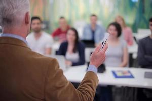 insegnante con un' gruppo di studenti nel aula foto