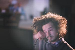 uomo Lavorando su computer nel buio ufficio foto