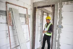 lavoratore asiatico dell'ingegnere edile dell'uomo di affari al cantiere della casa foto