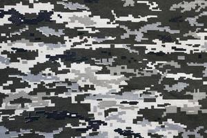 tessuto con struttura di ucraino militare pixeled camuffare. stoffa con Camo modello nel grigio, Marrone e verde pixel forme. ufficiale uniforme di ucraino soldati foto