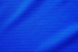 blu calcio maglia capi di abbigliamento tessuto struttura gli sport indossare sfondo, vicino su superiore Visualizza foto