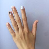 manicure di diverso colori su chiodo. femmina manicure su il mano su blu sfondo foto