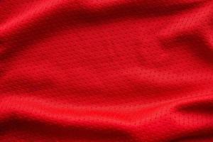 maglia da calcio in tessuto rosso per abbigliamento sportivo con sfondo a trama in rete d'aria foto