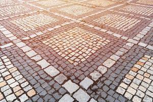 vecchio modello di pietre per lastricati. struttura dell'antico ciottolato tedesco nel centro della città. piccole piastrelle di granito. pavimenti grigio antico. foto