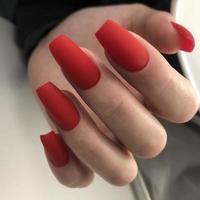 elegante di moda Opaco rosso femmina manicure.mani di un' donna con rosso manicure su Chiodi foto