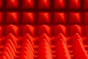 astratto rosso silicone piramidi stuoia avvicinamento sfondo foto