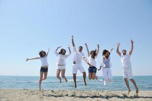 contento persone gruppo avere divertimento e in esecuzione su spiaggia foto