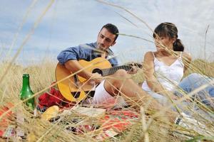 contento coppia godendo campagna picnic nel lungo erba foto