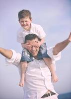 contento padre e figlio avere divertimento e godere tempo su spiaggia foto