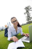 donna con il computer portatile nel parco foto