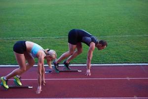 donna gruppo in esecuzione su Atletica gara traccia a partire dal inizio foto