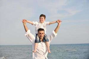 contento padre e figlio avere divertimento e godere tempo su spiaggia foto