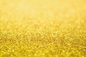 astratto glitter oro festivo natale texture sfocatura dello sfondo con luce bokeh foto
