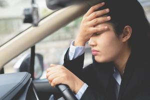 un' donna d'affari è guida un' macchina, lei è stressato di pesante traffico. foto