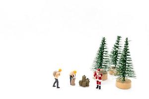 miniatura persone Santa Claus trasporto Borsa su bianca sfondo foto