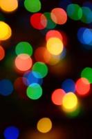 sfocato festivo colorato luci al di sopra di nero utile come sfondo. tutti principale colori incluso. rosso, giallo, verde e blu foto