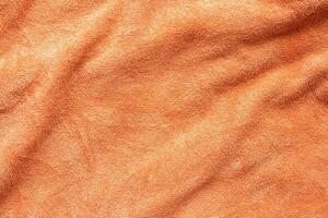 arancia asciugamano tessuto struttura superficie vicino su sfondo foto