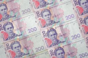 un' avvicinamento di un' modello di molti ucraino moneta banconote con un' par valore di 200 grivna. sfondo Immagine su attività commerciale nel Ucraina foto
