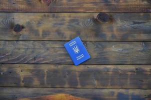 foto di il ucraino straniero passaporto, dire bugie su un' buio di legno superficie. il concetto di introducendo senza visto viaggio per ucraino cittadini