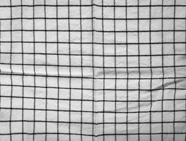 scacchi tovaglia tessuto o asciugamano. nero con bianca piazza modello foto