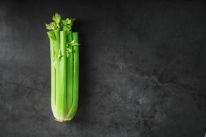 verde gambi di sedano su un' nero pietra sfondo. foto