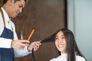 vicino su tiro mentre capelli elegante mentre spray acqua prima fare capelli tagliare e capelli costumista e trattamento mentre messa in piega capelli per cliente. professionale occupazione, bellezza e moda servizio occupazione. foto