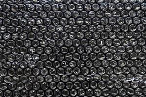 plastica avvolgere aria bolla confezione Materiale su nero sfondo copertura struttura foto