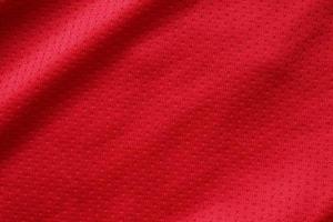 rosso gli sport capi di abbigliamento tessuto calcio camicia maglia struttura vicino su foto