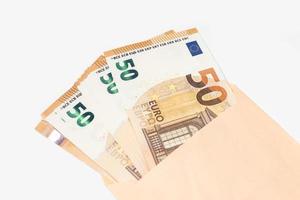 gruppo di 50 Euro banconote In arrivo su di un Busta su bianca sfondo foto