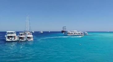 yacht parcheggio con turisti vicino bianca isola nel rosso mare. Egitto foto