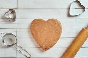 crudo Impasto nel forma di cuore su il tavolo foto