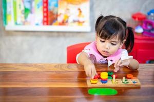 bambino poco ragazza giocando di legno giocattoli foto