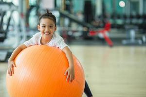 asiatico bambino ragazza con ginnastica palla foto